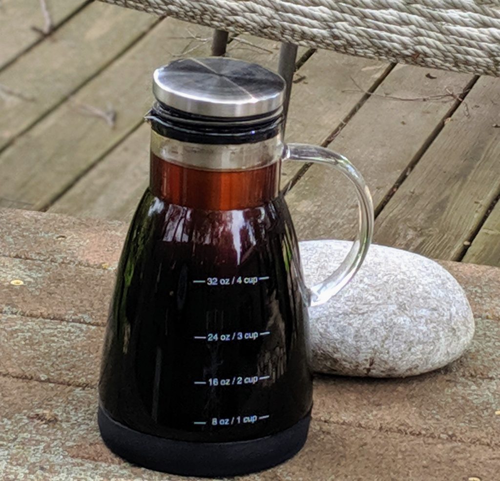 Cold brew coffee in cold brew maker next to rock